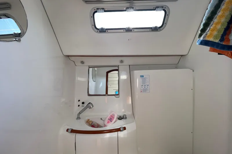 Slide: The Image of Head interior of 2007 Beneteau 393 yacht with sink, mirror, and window. - 6