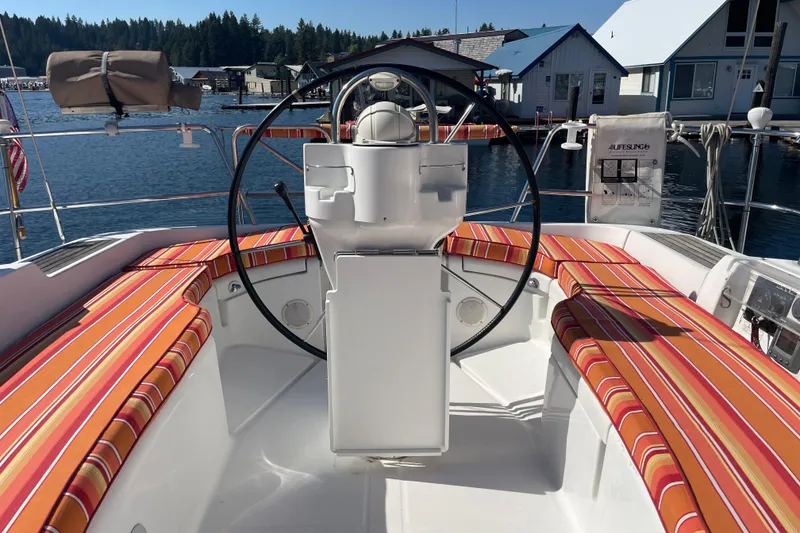 Slide: The Image of Cockpit of 2007 Beneteau 393 sailboat with striped seating, docked at marina. - 9