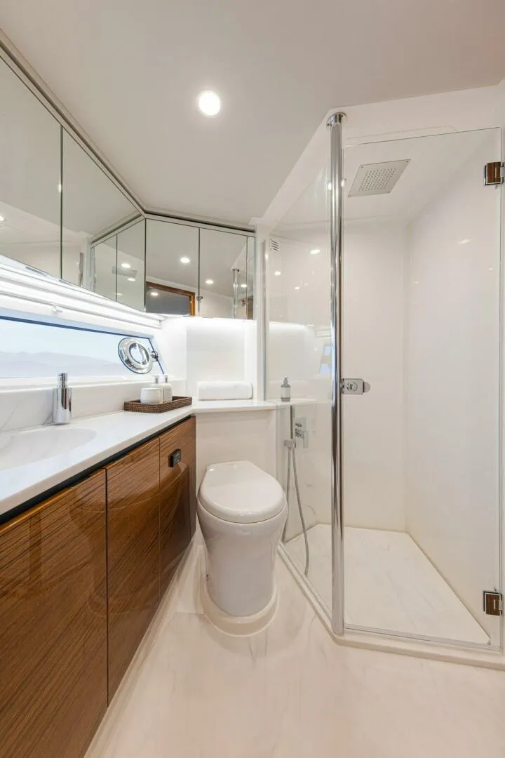 Slide: The Image of Riviera 78 Motor Yacht Port Ensuite 02 Gloss Teak Timber Finish Scaled - 3944902