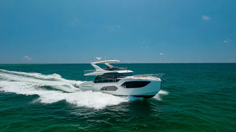 Slide: The Image of Dynamic Aerial View of Flybridge This image captures the sleek design of the 2027 60 Absolute Flybridge as it glides effortlessly through the water. The vessel's modern lines and spacious flybridge offer an inviting outdoor space, perfect for enjoying panoramic views while underway. The - 6492553