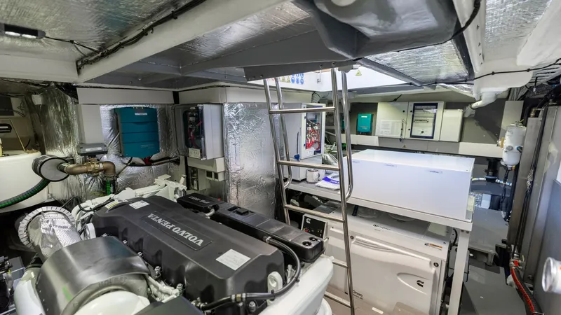 Slide: The Image of Engine Room with Volvo Penta Engine The engine room of the 2027 60 Absolute Flybridge showcases a powerful Volvo Penta engine, ensuring robust performance and reliability. The space is meticulously organized, featuring well-structured components and ample room for maintenance. High-quality - 6492547