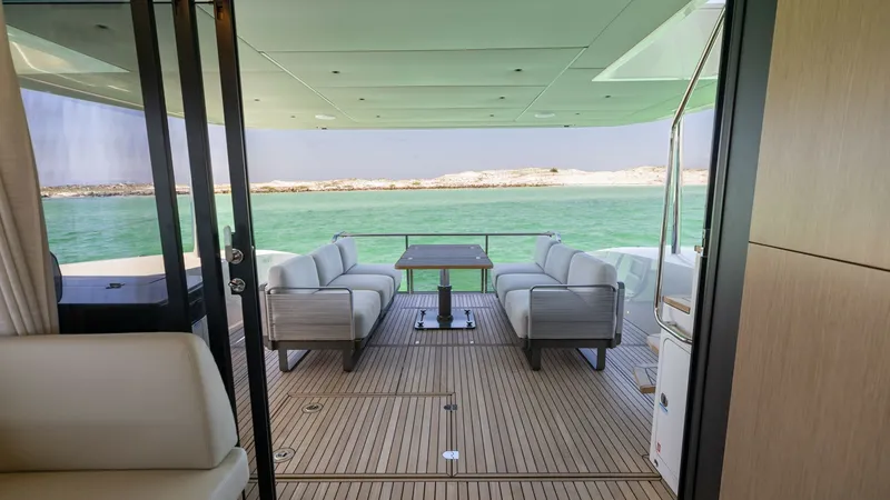Slide: The Image of Spacious Aft Deck with Seating The aft deck of the 2027 Absolute 60 Flybridge offers a luxurious outdoor living space with comfortable seating and a stylish wooden table, perfect for alfresco dining. Its expansive layout provides unobstructed views of the surrounding water, creating an - 6492505