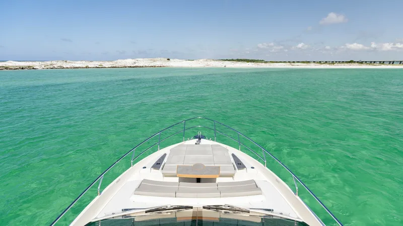 Slide: The Image of Bow Lounge with Panoramic Views The bow of the 2027 Absolute 60 Flybridge offers a luxurious lounging area with plush seating, perfect for relaxation while taking in expansive ocean views. The sleek design and high-quality finishes reflect Absolute's commitment to elegance and functiona - 6492533