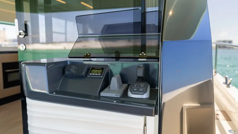 Slide: The Image of Flybridge Control Station This image showcases the sleek control station on the flybridge of the 2027 Absolute 60 Flybridge. Featuring state-of-the-art navigation and communication equipment, the station is designed for ease of use and efficiency. The surrounding area offers stunn - 6492517