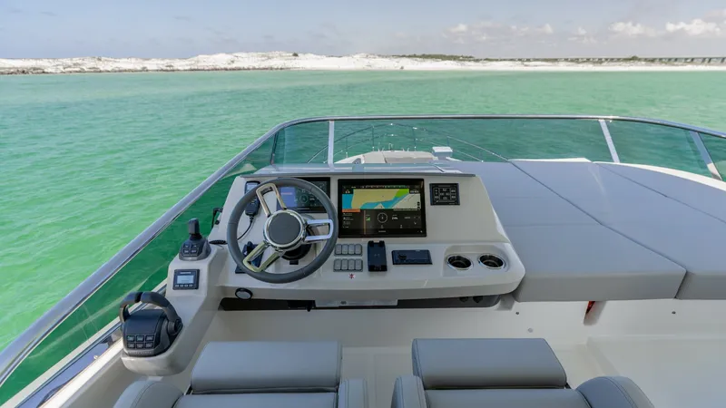 Slide: The Image of Flybridge Helm with Panoramic View Experience commanding views from the helm of the 2027 Absolute 60 Flybridge. This state-of-the-art control station features a sleek dashboard equipped with advanced navigation systems and ergonomic seating for optimal comfort. Enjoy seamless visibility an - 6492528