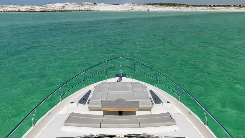 Slide: The Image of Bow Lounge Area with Sunpads The 2027 60 Absolute Flybridge features a luxurious bow lounge area with expansive sunpads, perfect for relaxation. The sleek design offers unobstructed views of the surrounding waters, while the high-quality materials ensure comfort and style. This space - 6492530