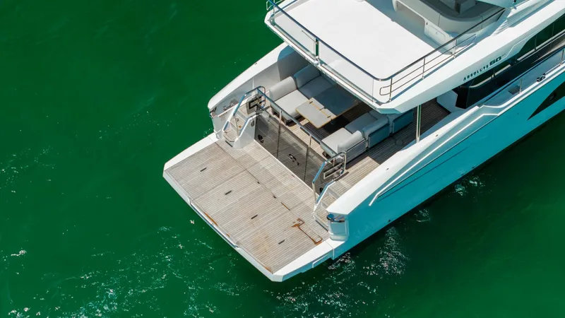 Slide: The Image of Spacious Aft Deck with Swim Platform The aft deck of the 2027 Absolute 60 Flybridge features a generous swim platform perfect for relaxation and easy water access. Sleek, modern design meets functionality with ample seating and elegant finishes. The stainless steel railings and teak flooring - 6492551