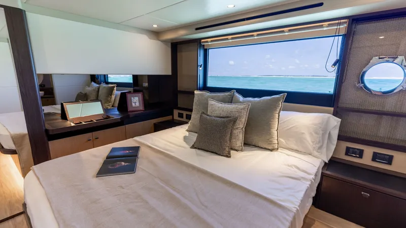 Slide: The Image of Luxurious VIP Stateroom The master stateroom of the 2027 60 Absolute Flybridge offers a serene retreat with panoramic sea views through large windows. Featuring a plush double bed adorned with elegant linens, this space is complemented by rich wood finishes and ample storage. So - 6492498