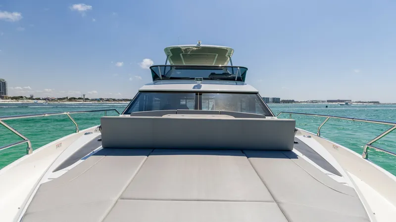 Slide: The Image of Spacious Bow Sunpad Area The 2027 Absolute 60 Flybridge showcases a luxurious bow with an expansive sunpad, perfect for relaxation under the sun. The sleek lines and modern design complement the vessel's elegant exterior, offering stunning panoramic views of the surrounding water - 6492518