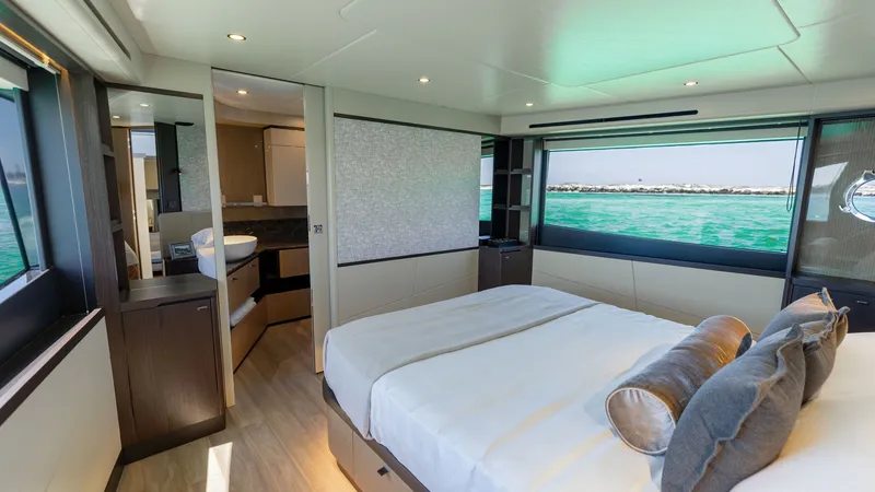 Slide: The Image of Master Stateroom with Ocean View The master stateroom of the 2027 60 Absolute Flybridge features a spacious layout with a luxurious queen-sized bed. Large windows offer panoramic ocean views, enhancing the sense of tranquility and openness. Elegant finishes, soft lighting, and high-quali - 6492493