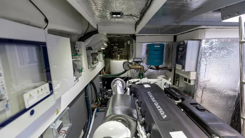 Slide: The Image of Engine Room with Volvo Penta Engines The engine room of the 2027 60 Absolute Flybridge showcases powerful Volvo Penta engines, ensuring reliability and performance. The space is well-organized and features advanced insulation for noise reduction. Modern engineering and meticulous attention t - 6492544