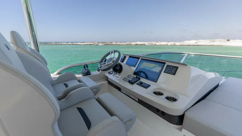 Slide: The Image of Flybridge Helm Station The 2027 60 Absolute Flybridge helm station boasts state-of-the-art navigation equipment, ensuring a seamless piloting experience. Ergonomically designed seats offer comfort and style, while the intuitive dashboard layout provides easy access to all contr - 6492527