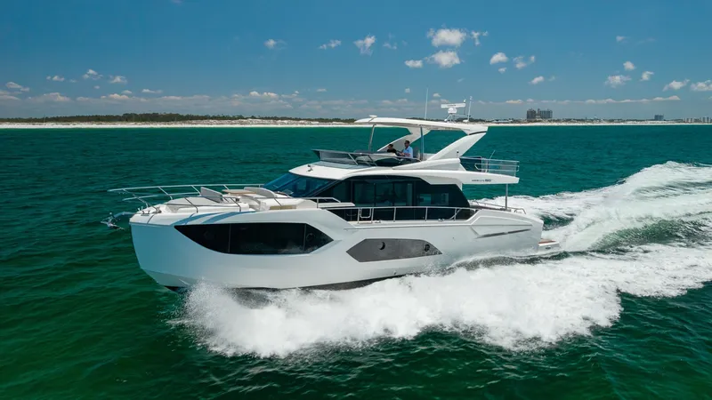 The Image of Side View of 2027 60 Absolute Flybridge This striking side view of the 2027 60 Absolute Flybridge showcases its sleek, modern design and spacious flybridge. The vessel cuts through the water with ease, highlighting its advanced hull architecture and smooth performance. Large panoramic windows p - 6492472