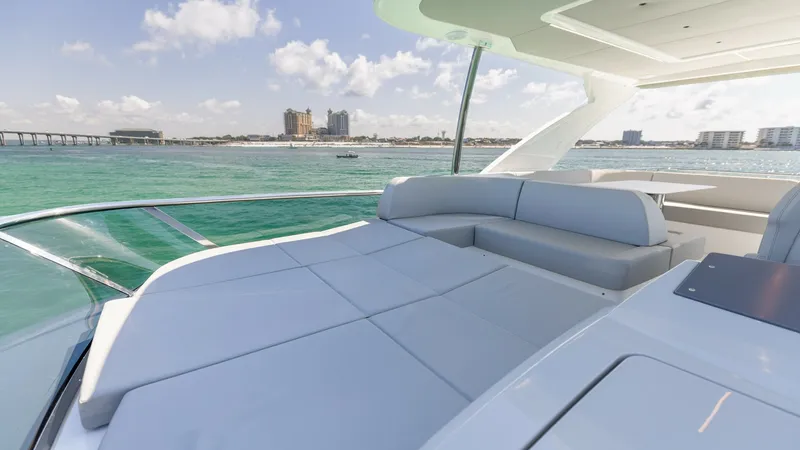 Slide: The Image of Flybridge Sunpad with Ocean View Experience ultimate relaxation on the expansive sunpad located on the flybridge of the 2027 60 Absolute Flybridge. This area offers plush seating with panoramic ocean views, perfect for lounging under the sun. The sleek design and modern finishes enhance - 6492532