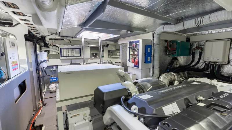 Slide: The Image of Engine Room with Advanced Equipment The engine room of the 2027 60 Absolute Flybridge showcases advanced engineering with spacious layout for easy maintenance. It features well-organized systems and high-quality components, ensuring efficient operations. The area is designed for optimal fun - 6492546