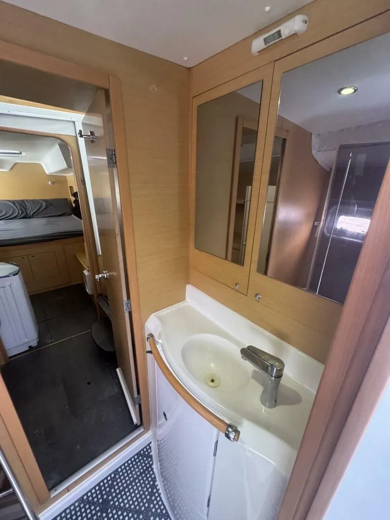 Slide: The Image of 2013 Lagoon 380 S2 - Owner Version This boat is the popular S2, 3 cabin owners' version. The cockpit is protected by a fiberglass hard top with sliding panel over the helm position to allow the skipper excellent visibility of the boat. The boat has new antifoul paint (May 2023), new zincs, - 4791979