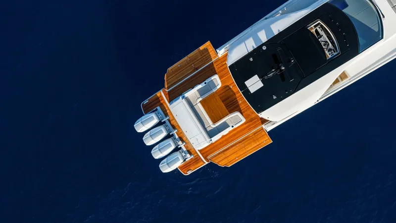 Slide: The Image of Aerial View of Aft Deck - Valhalla 55 Sport Yacht This striking aerial view showcases the aft deck of the 2027 Valhalla Boatworks 55 SY. Featuring a sleek design with a spacious teak deck, it offers ample seating and a state-of-the-art helm station. The powerful quad outboard engines promise exhilarating - 6332945