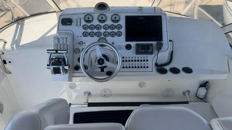 Slide: The Image of Helm Station with Electronics Console The helm station of the 2008 Fountain 38 Sportfishing Cruiser features a well-equipped electronics console, providing essential controls and navigation tools at your fingertips. The steering wheel is centrally located, surrounded by an array of gauges and - 7788479