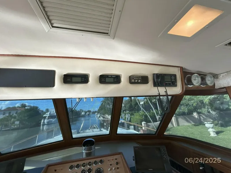Slide: The Image of 63' Hatteras pilothouse helm overhead electronics - 5444735