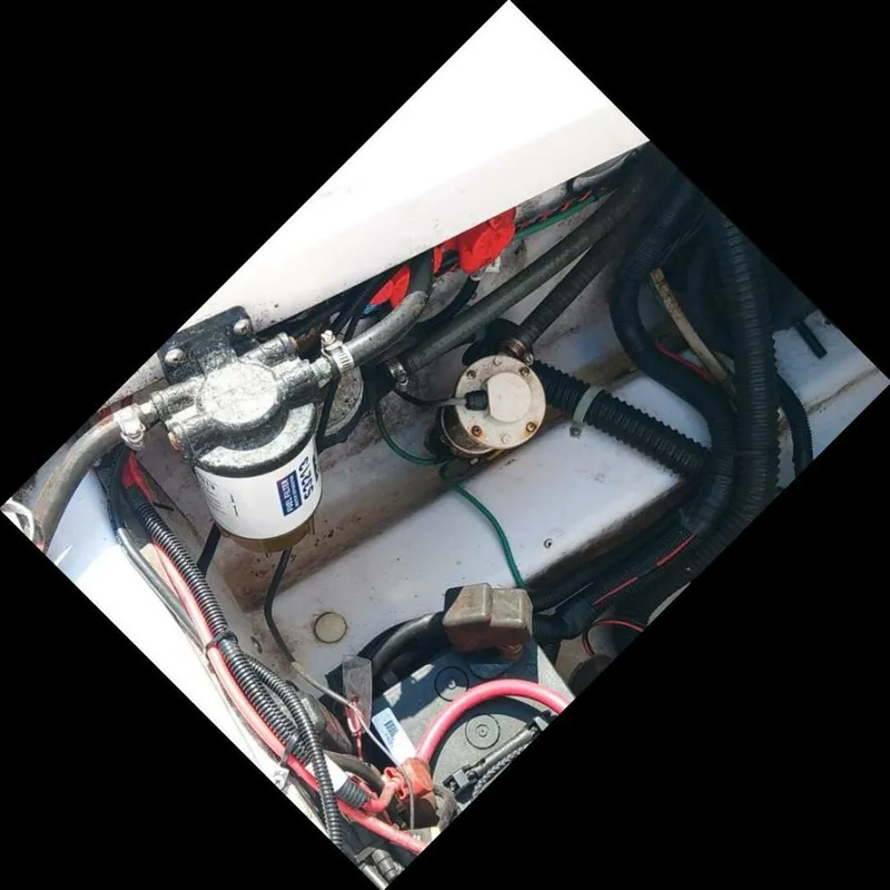 Slide: The Image of Pro-Line 32 Express View inside aft deck hatch looking starboard. Fuel filter/Water separator in view as well as bilge pump. - 5533913