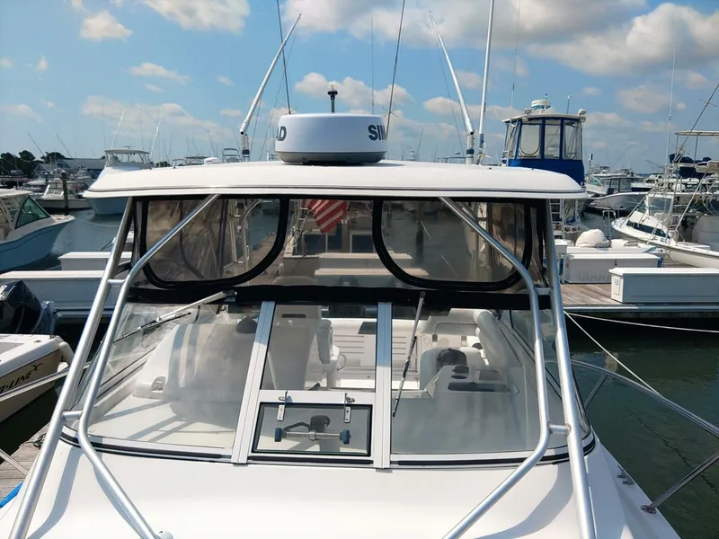 Slide: The Image of Pro Line 32 Express Hard Top View of Hard Top, Radar dome, and outriggers from bow looking aft - 5490476