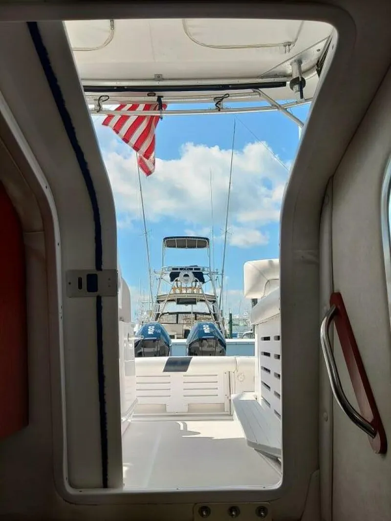 Slide: The Image of Pro-Line 32 Express View looking aft from companionway heading into cabin, sliding hatch open. - 5533924