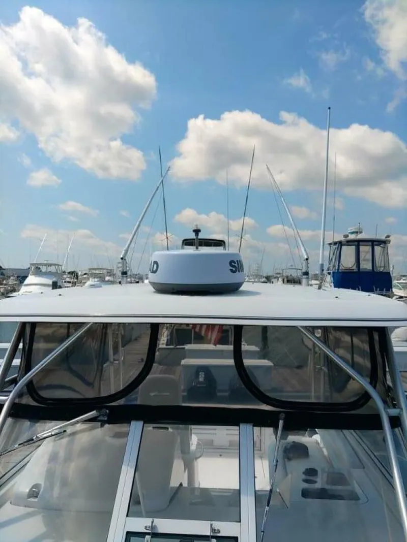 Slide: The Image of Pro Line 32 Express Hardtop Detail Detailed view of hard top from bow looking aft, with SIMRAD radar dome in view - 5490477