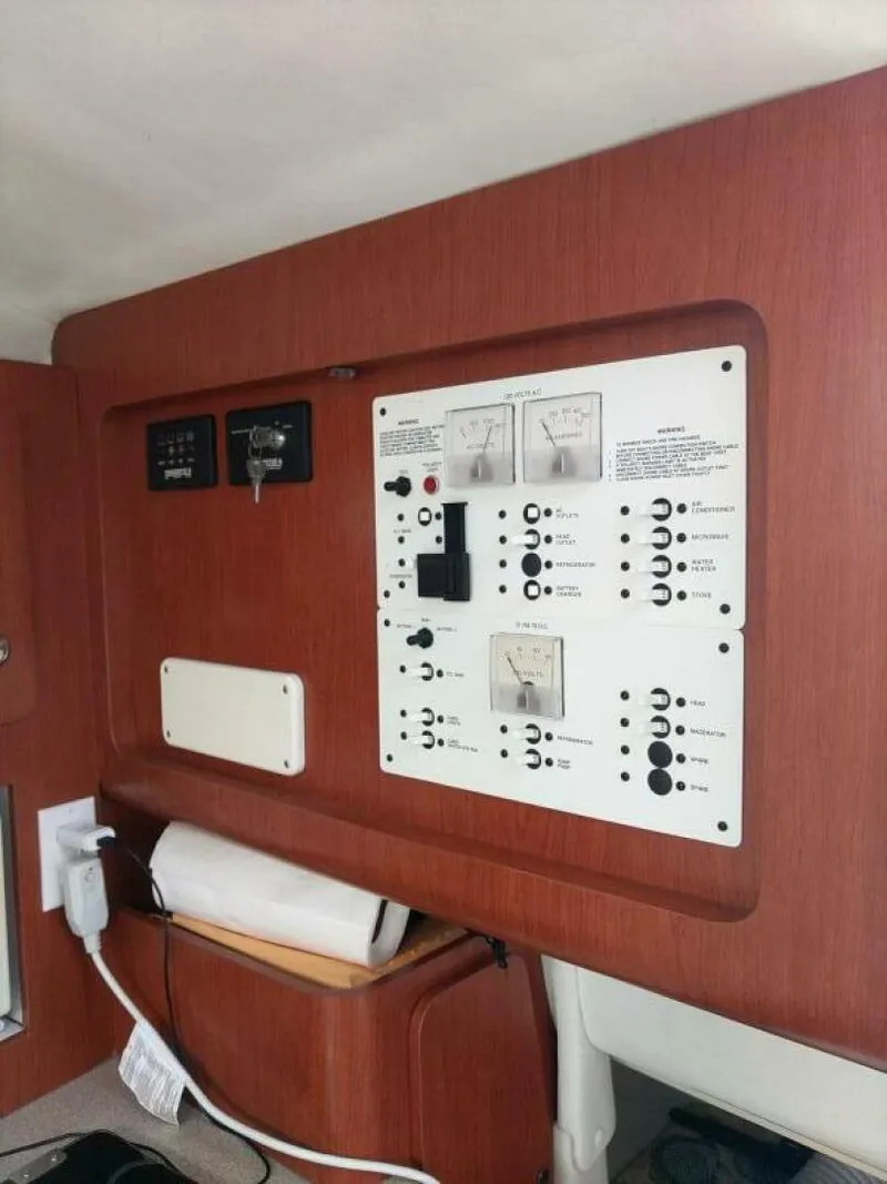 Slide: The Image of Pro-Line 32 Express Facing aft, starboard electrical breaker panel, above under helm berth. - 5533927