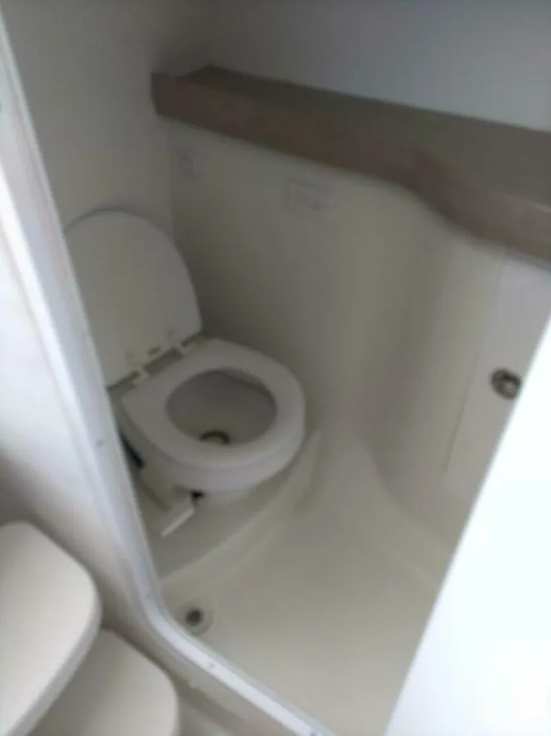 Slide: The Image of Pro-Line 32 Express Port side head/enclosed shower. Vacuflush toilet in view and vanity. - 5533931