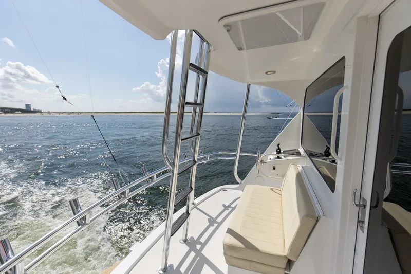 Slide: The Image of 2007 68 Hatteras 68 Enclosed Bridge REFUGE Aft Flybridge Helm Station - 5535627