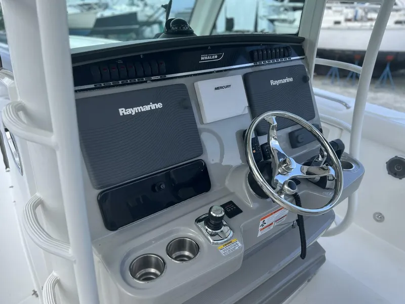 Slide: The Image of 2014 Boston Whaler 350 Outrage Helm from Port with all Electronics Covers on - 5576104