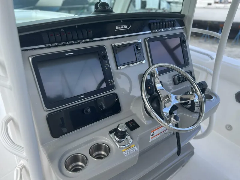 Slide: The Image of 2014 Boston Whaler 350 Outrage Helm from port with electronics uncovered - 5576106