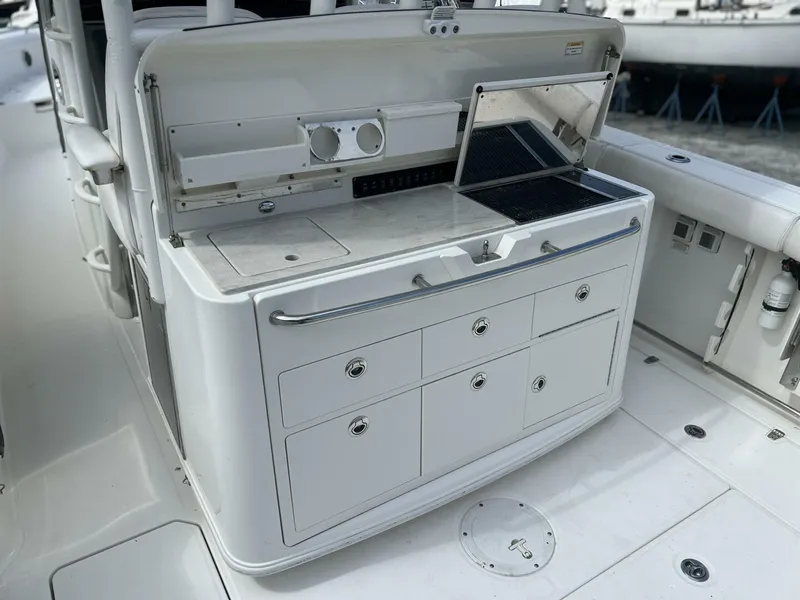 Slide: The Image of 2014 Boston Whaler 350 Outrage Summer Kitchen Leaning Post open with Kenyon Grill open, looking from port side - 5576110