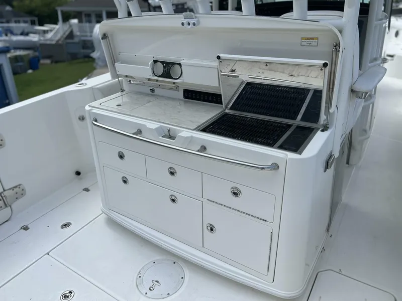 Slide: The Image of 2014 Boston Whaler 350 Outrage Summer Kitchen Leaning Post open with Kenyon Grill open, looking from starboard side - 5576111