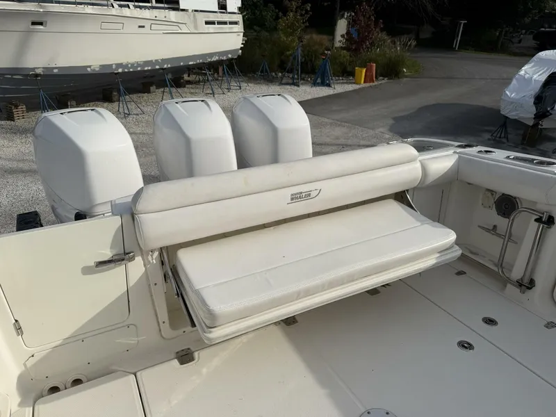Slide: The Image of 2014 Boston Whaler 350 Outrage cockpit with rear bench seat open, looking from starboard side - 5681319