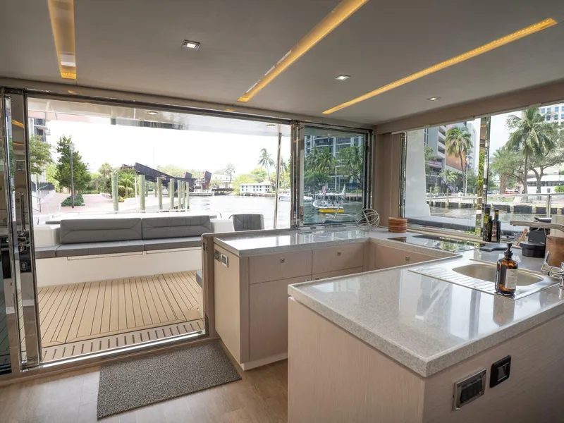 Slide: The Image of Alva OE 54 Looking Aft From Galley With Open Windows Ocean Eco 54 galley aft view with large windows open to cockpit - 5603801