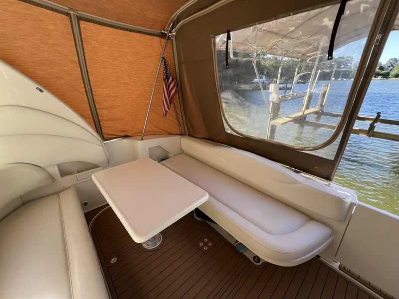 Slide: The Image of 2002 Sea Ray 360 Sundancer Aft Seating with Removable table and Faux Teak SeaDek in the Cockpit looking aft - 5645763