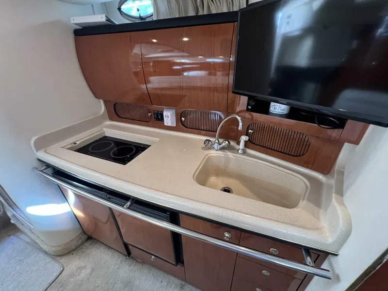 Slide: The Image of 2002 Sea Ray 360 Sundancer Galley with Cooktop and Sink covers off - 5645784