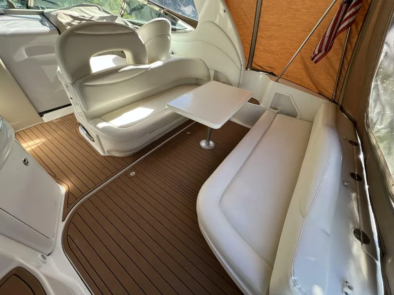 Slide: The Image of 2002 Sea Ray 360 Sundancer Aft Seating with Removable table and Faux Teak SeaDek in the Cockpit looking forward - 5645764