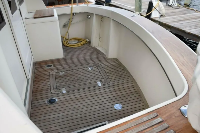 Slide: The Image of Teak cockpit sole and coverboards, boarding treads to either side, cockpit freezer, hatch to lazarette. - 5711479