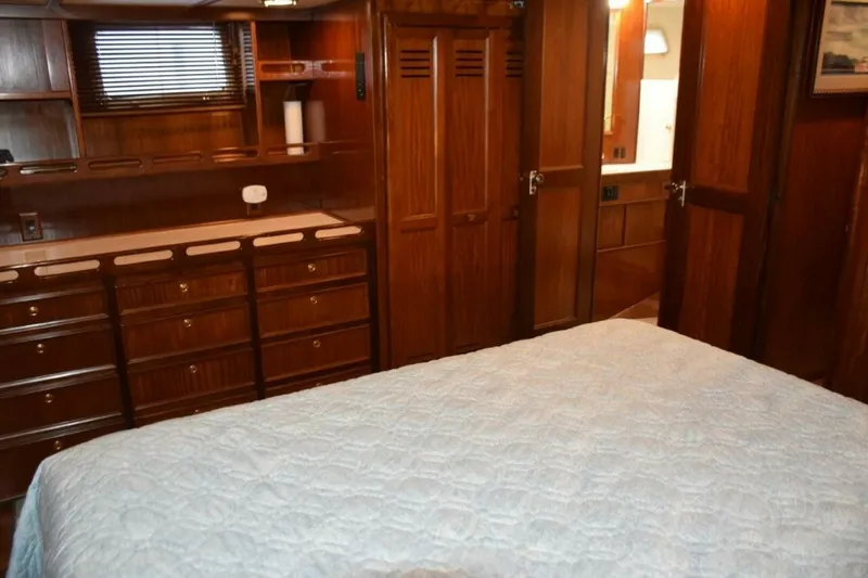 Slide: The Image of Portlights to either side of the stateroom and note abundance of drawers in dresser next to cedar lined hanging closet and head entry door - 5711510