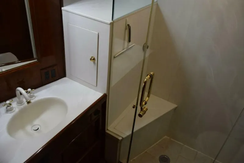 Slide: The Image of Master vanity top with mirrored medicine cabinet and glass shower enclosure with seat. - 5711511