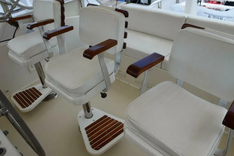 Slide: The Image of Three teak ladderback chairs with arm and footrests. - 5711475