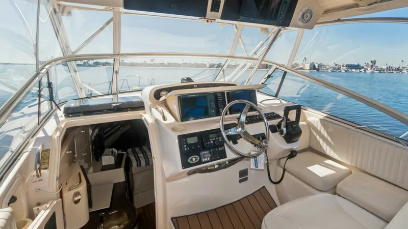 Slide: The Image of 2006 Grady-White 330 Express - "POLE POSITION": Helm Station and Cockpit Seating The helm station of the 2006 Grady-White 330 Express features a sleek, ergonomic design with state-of-the-art navigation equipment and a comfortable captain's chair. The surrounding cockpit area offers plush seating and excellent visibility, enhancing the - 6572964