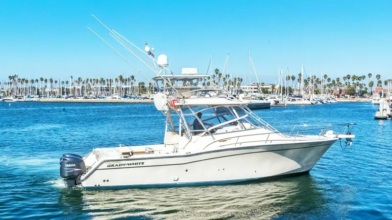 The Image of 2006 Grady-White 330 Express - "POLE POSITION": This image showcases the sleek side profile of the 2006 Grady-White 330 Express, featuring its sturdy hull and spacious deck layout. The vessel is equipped with twin Yamaha outboard engines for powerful performance on the water. The cabin's large windows - 6572951