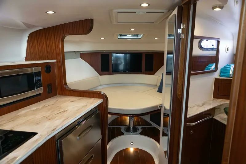 Slide: The Image of Pursuit 38 - TRACKER - Cabin View of Galley, Berth, and Head 2018 Pursuit 38 Center Console TRACKER - 7680279