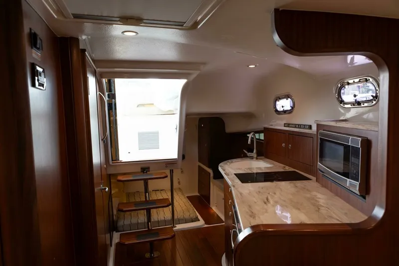 Slide: The Image of Pursuit 38 - TRACKER - Cabin Entrance and Galley 2018 Pursuit 38 Center Console TRACKER - 7680277