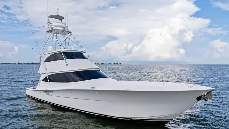 Slide: The Image of Viking 72 Enclosed Bridge Exterior View This image showcases the sleek exterior of the 2021 Viking 72 Enclosed Bridge. The yacht's streamlined design and modern lines are complemented by its spacious enclosed bridge, offering both functionality and style. The vessel's robust hull and sophistica - 7377953