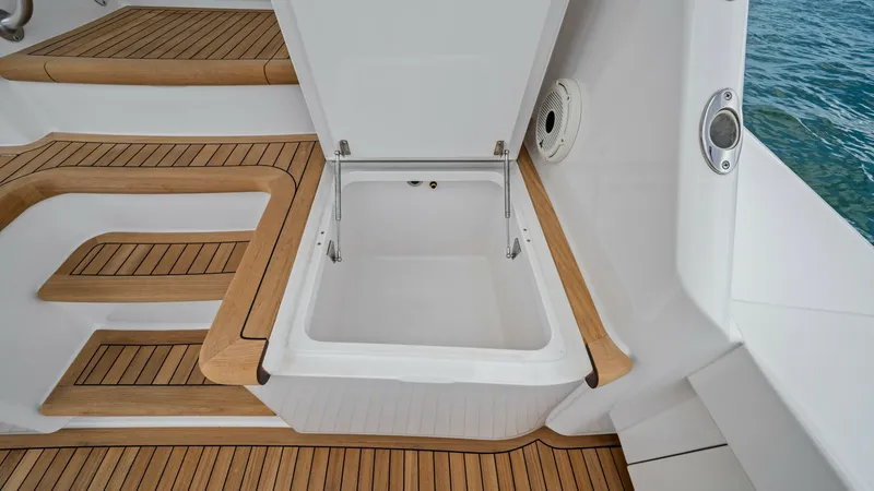 Slide: The Image of Teak Deck with Storage Hatch This image showcases the teak deck of the 2021 Viking 72 Enclosed Bridge, featuring a neatly integrated storage hatch. The teak steps provide a luxurious and durable finish, enhancing the vessel's aesthetic appeal. The hatch offers convenient storage spac - 7377939
