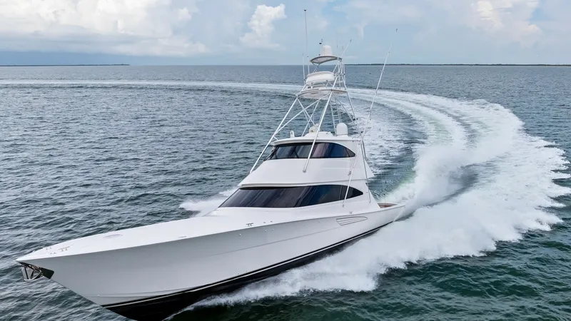 Slide: The Image of Dynamic Bow View in Motion This striking image captures the Viking 72 Enclosed Bridge slicing through the water, showcasing its sleek, aerodynamic design. The vessel's powerful performance is highlighted by the impressive wake it creates, while the enclosed bridge offers superior v - 7377967